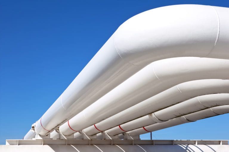 Image of white pipeline against blue skies