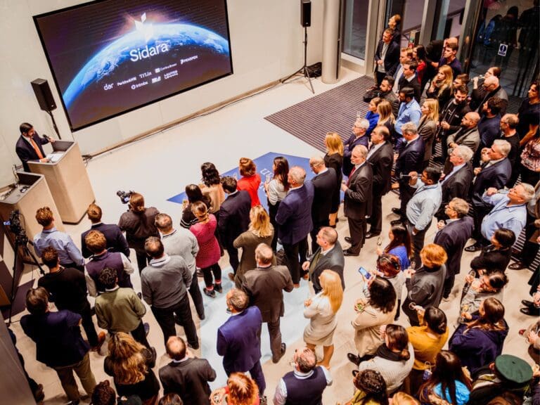 An audience of people watching a presentation