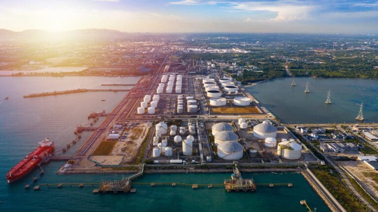 aerial image of oil and gas industrial zone surrounded by sea