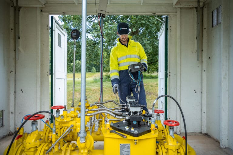 Male penspen employee inspecting PRI station in the UK.