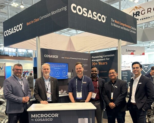 Image of Penspen and Cosasco employees smiling at camera at AMPP conference 
