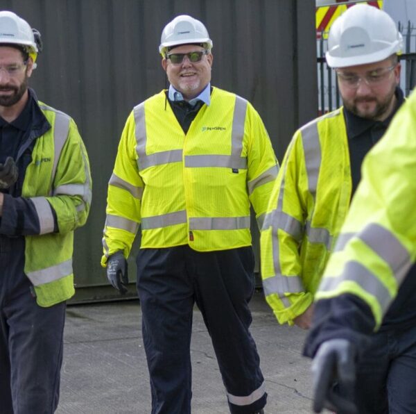 Men in high vis PPE walking outside