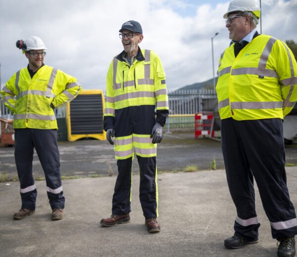 Three men in high vis PPE outside