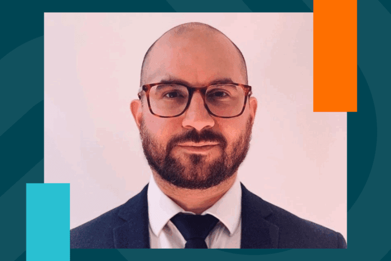 A man in a suit and tie and glasses.