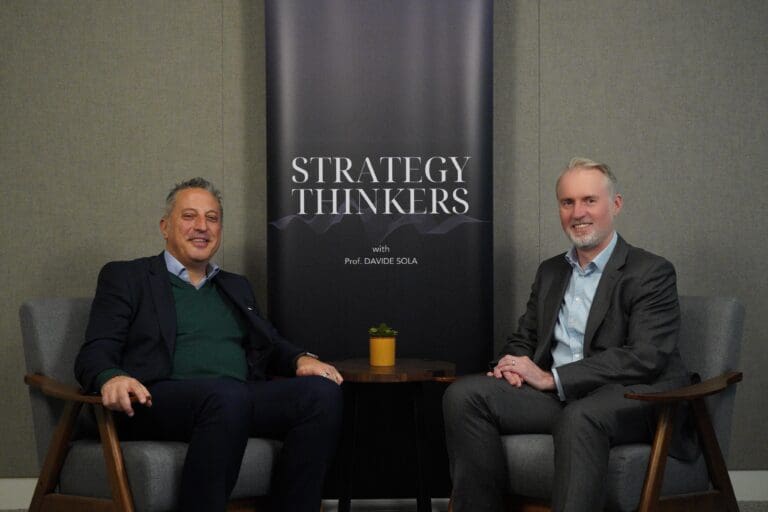 Image of Penspen CEO, Peter O'Sullivan sat at table with Davide Sola.