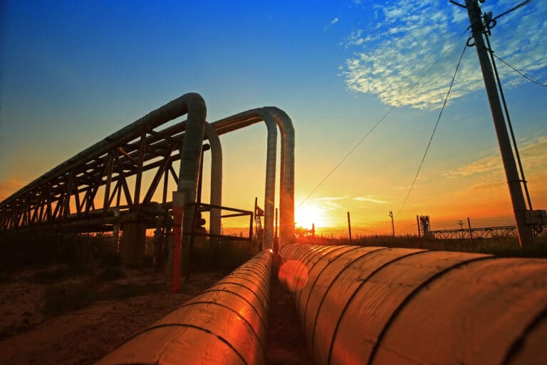 An image of sunrising over some pipelines in the Middle East