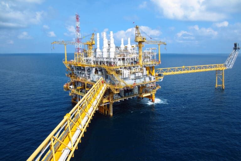 An image of an offshore platform. It is painted yellow.