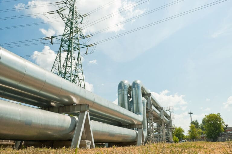pipeline and power lines against the background of blue sky and clouds.