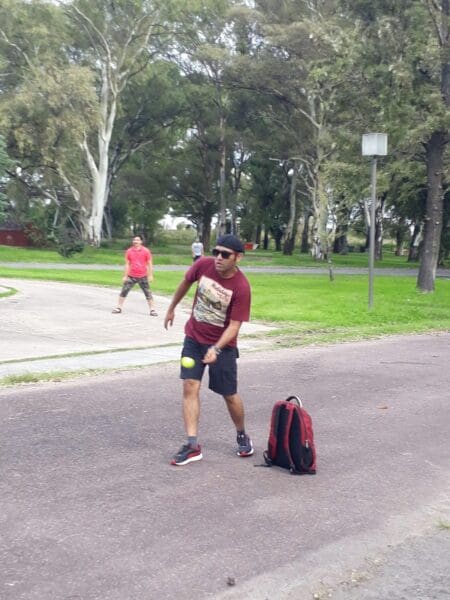 Penspen employee Nilesh Prakade plays cricket outside in the street